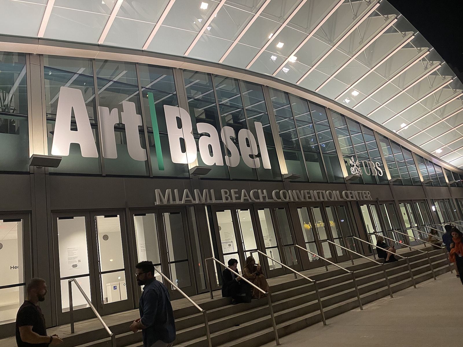 Art Basel signage at the Miami Beach Convention Center entrance at night