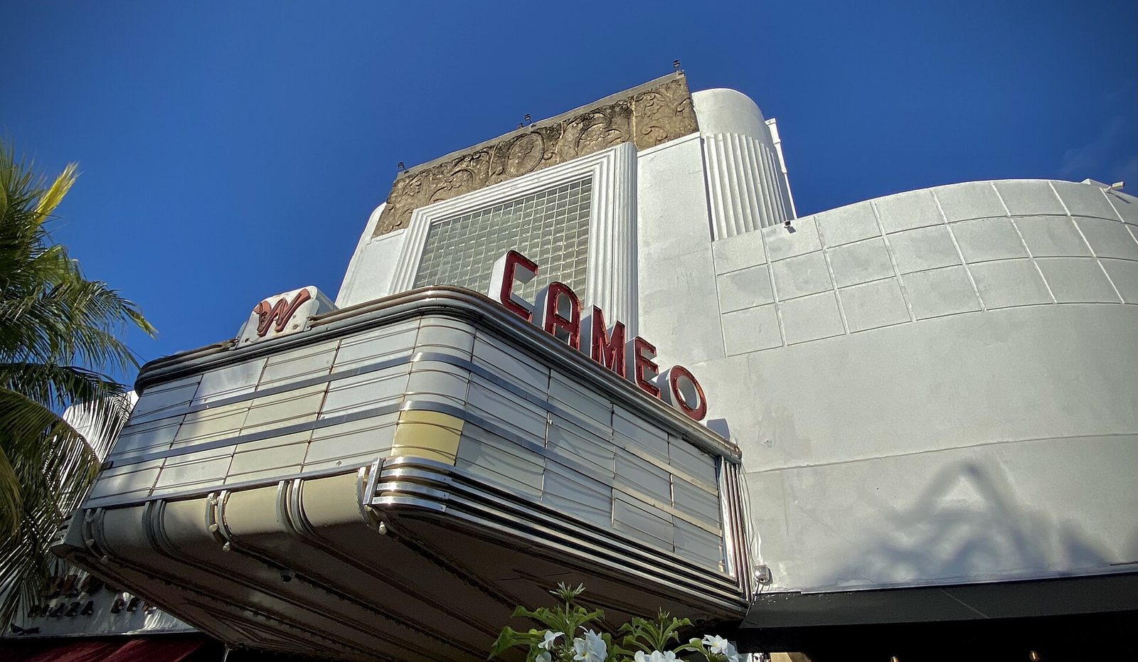 The Art Deco marquee of the Cameo Theater on Washington Avenue, with CAMEO in red letters against a white facade