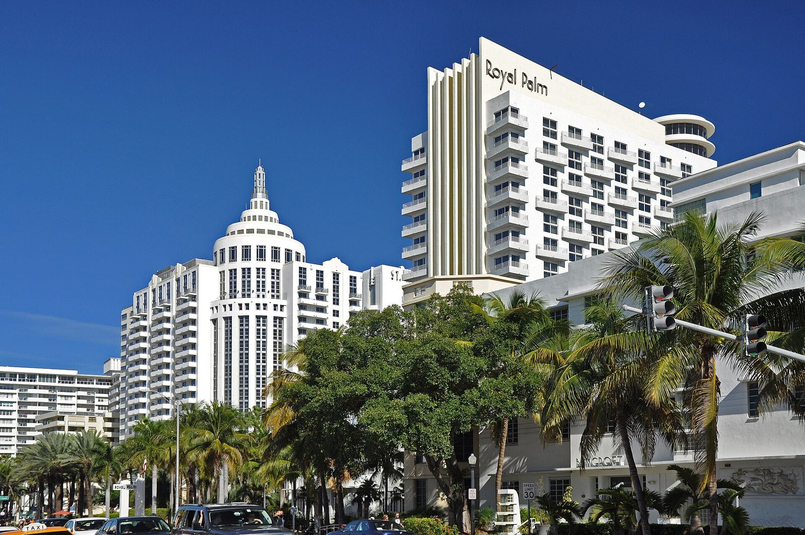 High-rise hotels along Collins Avenue behind palm trees