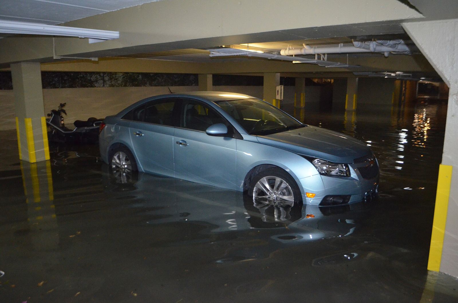 A car standing in floodwater inside a Miami Beach garage