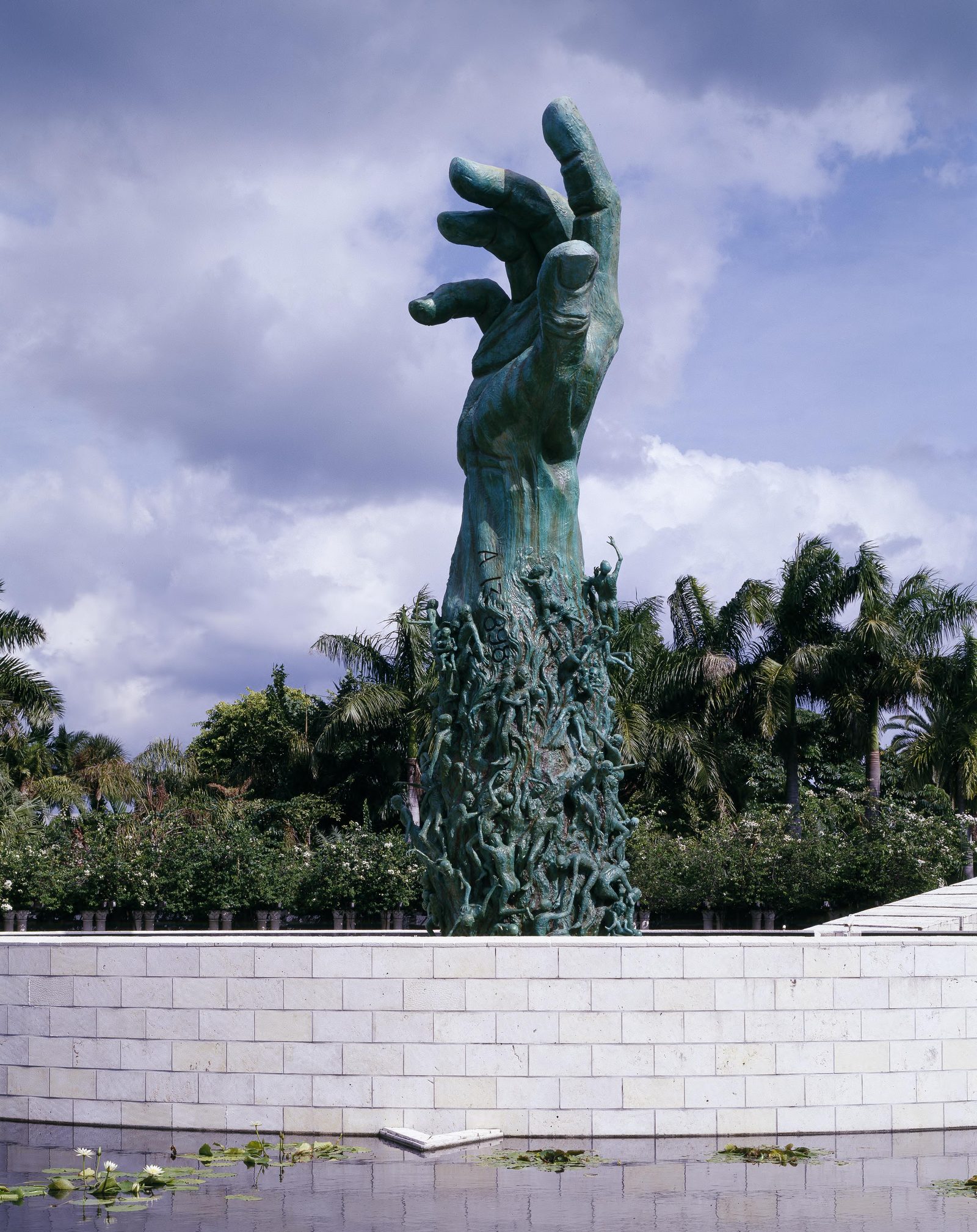 The Holocaust Memorial's bronze Sculpture of Love and Anguish rising above its reflecting pool in Miami Beach